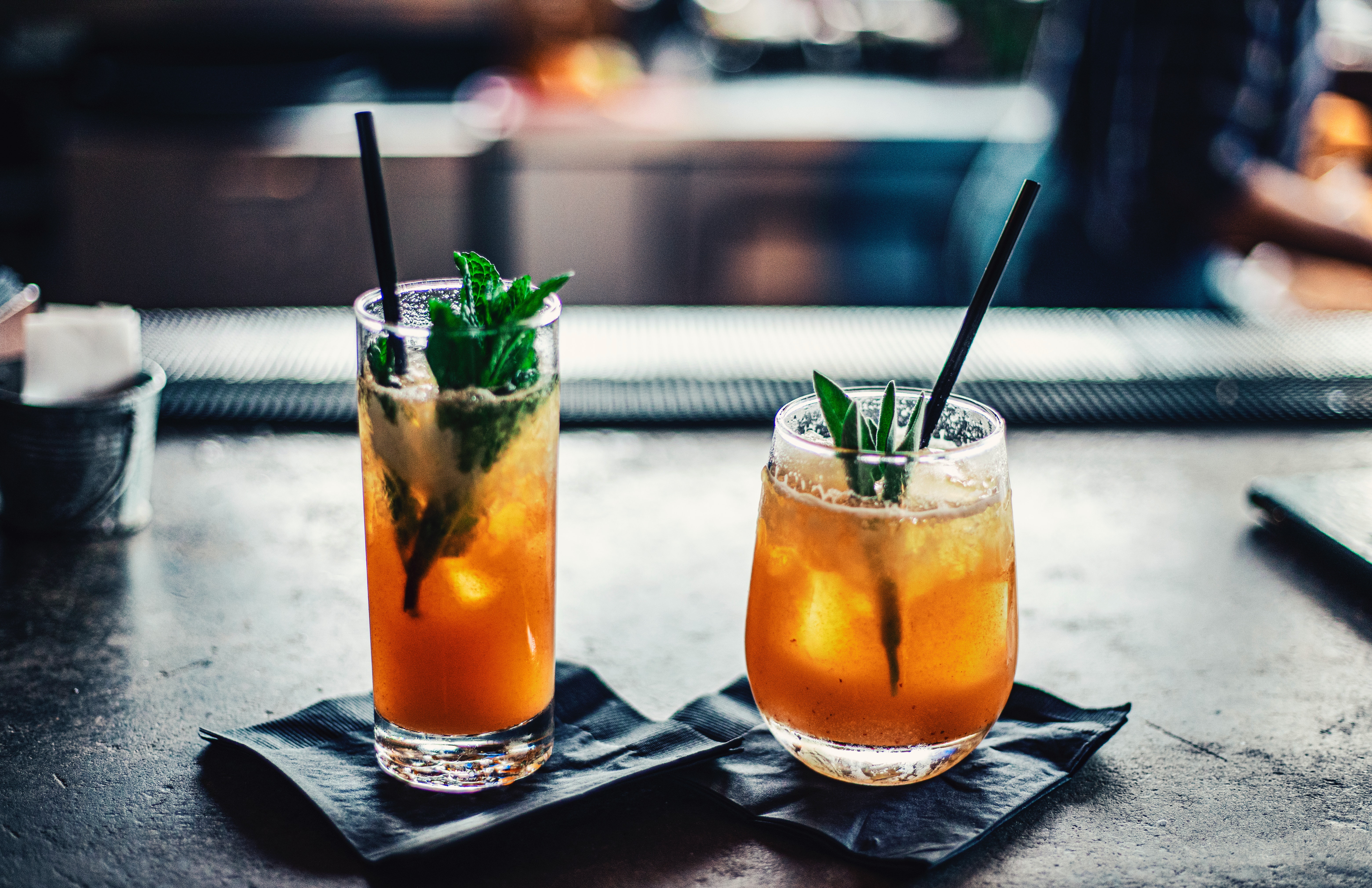 Two different cocktailglasses filled with the same drink on a table.