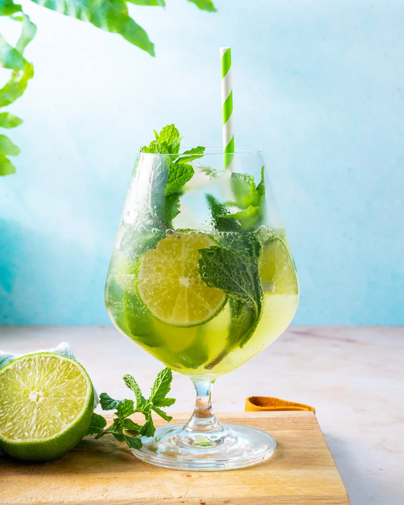 Glass filled with a Mojito.